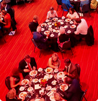 Overhead photo of donors sitting at fundraising dinner table